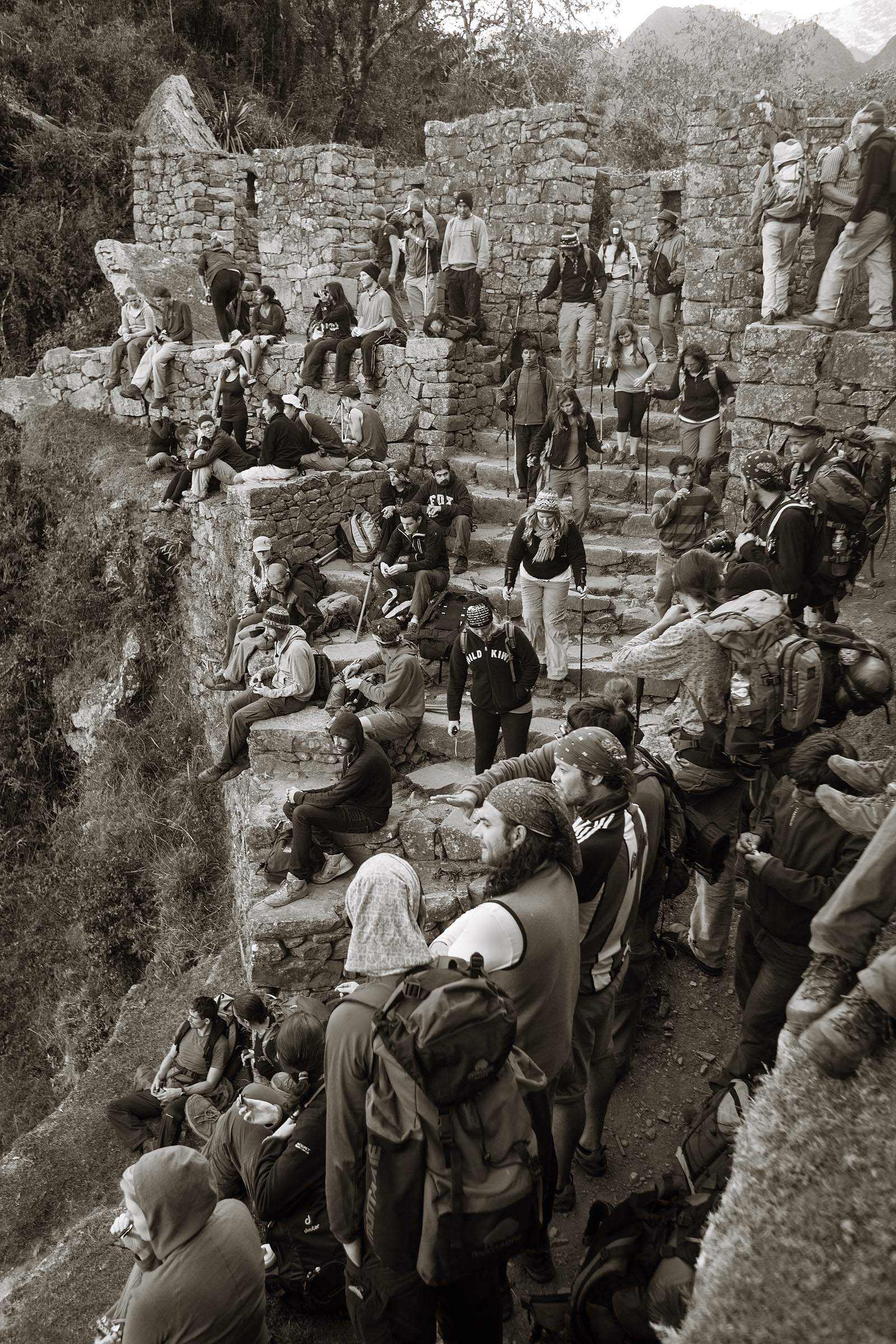 Trekkers emerge through the Sun Gate to get their first view of the ancient city of Machu Picchu.
